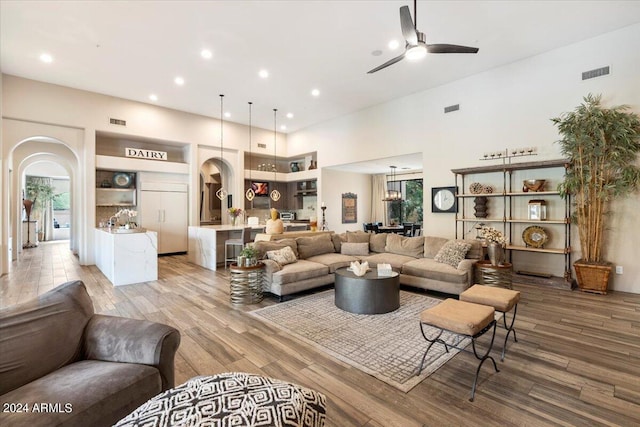 living room featuring hardwood / wood-style floors and ceiling fan