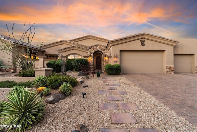 mediterranean / spanish-style home with a garage