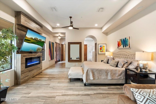 bedroom with light hardwood / wood-style floors and ceiling fan