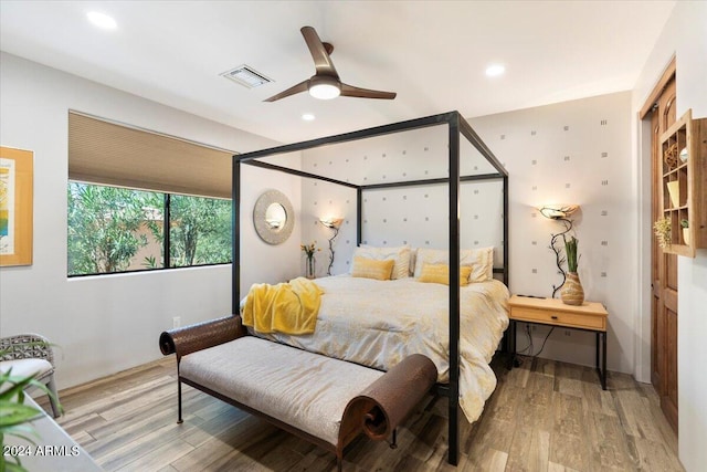 bedroom with hardwood / wood-style flooring and ceiling fan