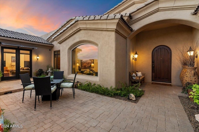 view of patio terrace at dusk