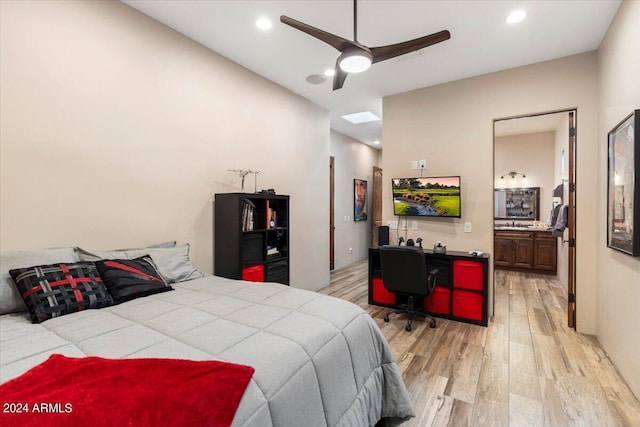 bedroom featuring ensuite bath, ceiling fan, and light hardwood / wood-style floors