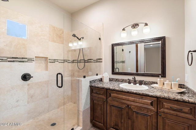 bathroom featuring vanity and a shower with door