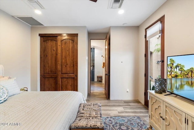 bedroom featuring light wood-type flooring and a closet