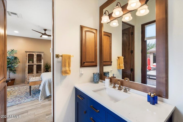 bathroom featuring hardwood / wood-style floors, vanity, and ceiling fan