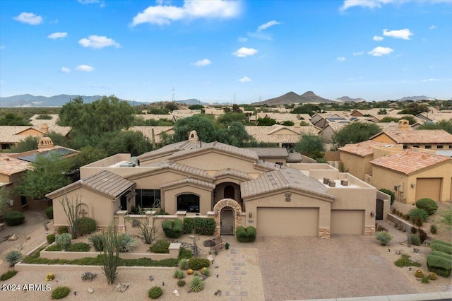 view of front of house with a mountain view and a garage