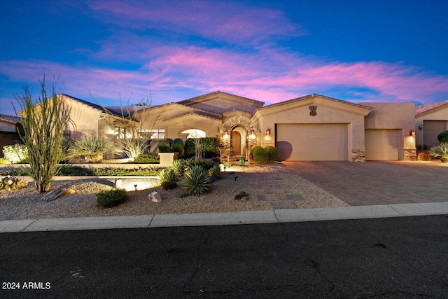 mediterranean / spanish house with a garage