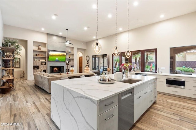 kitchen featuring a center island with sink, light hardwood / wood-style floors, and appliances with stainless steel finishes