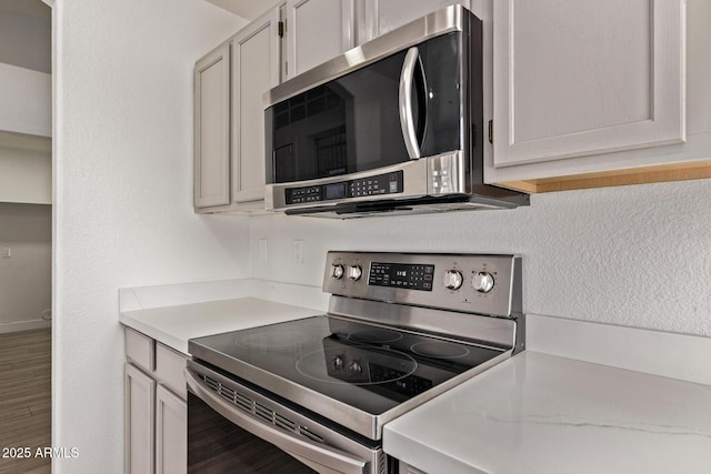 kitchen with light countertops, wood finished floors, and appliances with stainless steel finishes