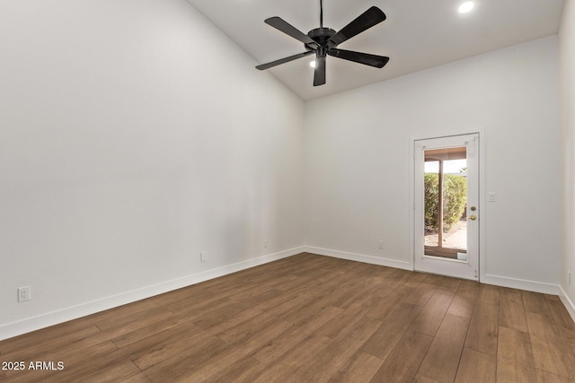 unfurnished room featuring baseboards, a ceiling fan, and dark wood-style flooring