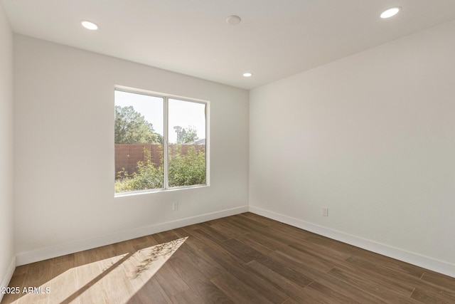 empty room with recessed lighting, baseboards, and dark wood-style floors