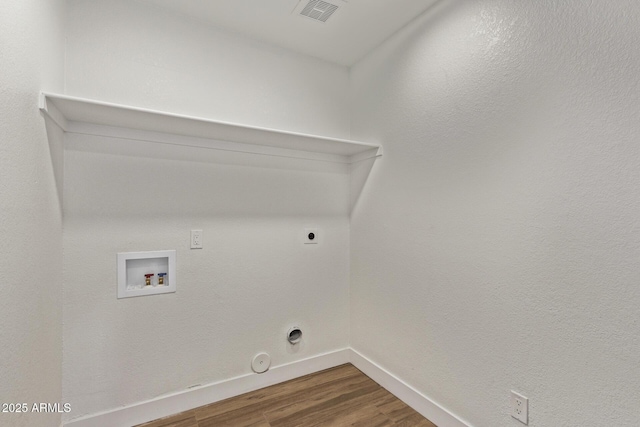 washroom with wood finished floors, hookup for a gas dryer, baseboards, hookup for a washing machine, and laundry area