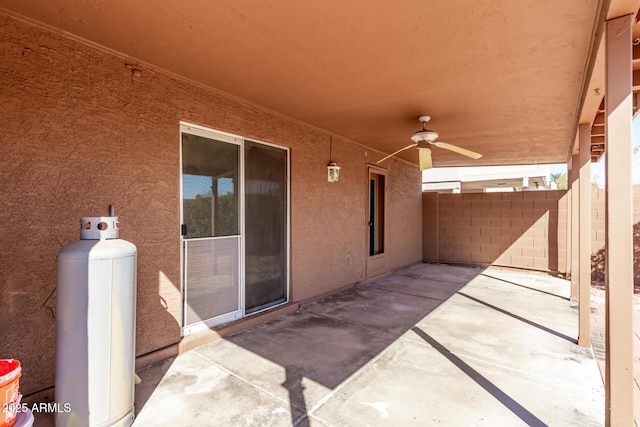 view of patio / terrace with a ceiling fan and fence