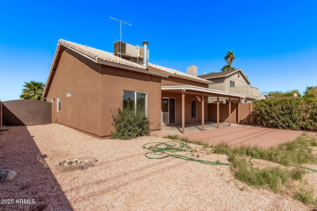 back of house featuring stucco siding, fence, and a patio area