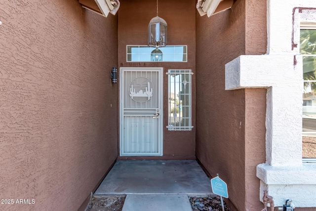 doorway to property with stucco siding