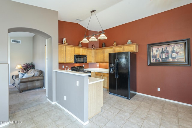 kitchen with light tile patterned floors, hanging light fixtures, black appliances, vaulted ceiling, and kitchen peninsula