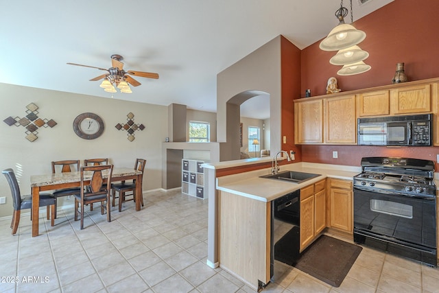 kitchen with light brown cabinetry, sink, decorative light fixtures, kitchen peninsula, and black appliances