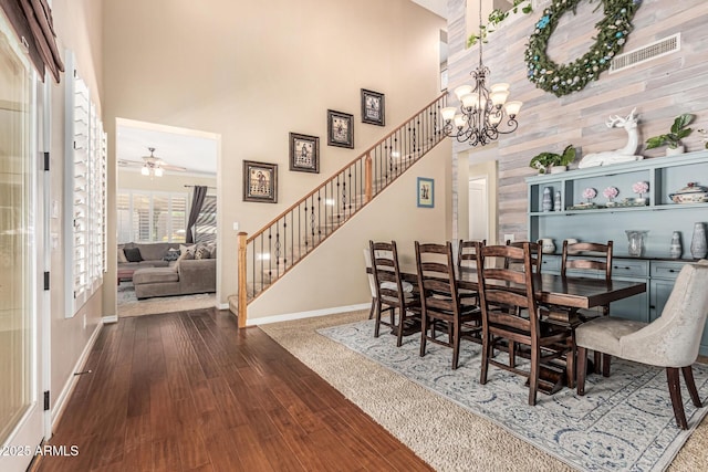 4463 S Oregon Ct, Chandler, AZ 85248 - dining area featuring a towering ceiling, baseboards, stairs, ceiling fan, and wood finished floors