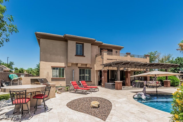 4463 S Oregon Ct, Chandler, AZ 85248 - back of property featuring a pergola, a patio, stucco siding, exterior kitchen, and a balcony