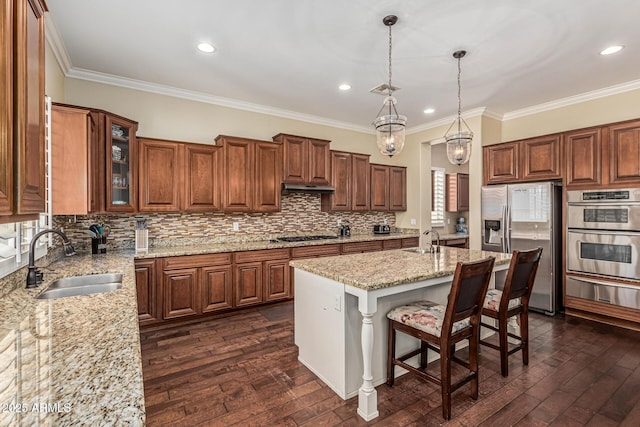 4463 S Oregon Ct, Chandler, AZ 85248 - kitchen featuring stainless steel appliances, a sink, a warming drawer, under cabinet range hood, and crown molding