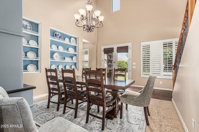 4463 S Oregon Ct, Chandler, AZ 85248 - dining area with baseboards, a chandelier, a high ceiling, and stairway