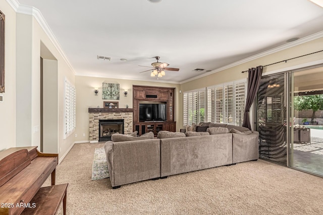 4463 S Oregon Ct, Chandler, AZ 85248 - living room featuring light colored carpet, plenty of natural light, ornamental molding, ceiling fan, and a stone fireplace