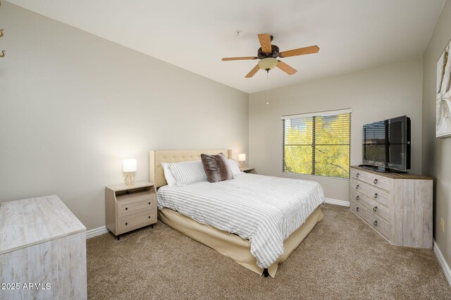 bedroom featuring baseboards, light colored carpet, and ceiling fan