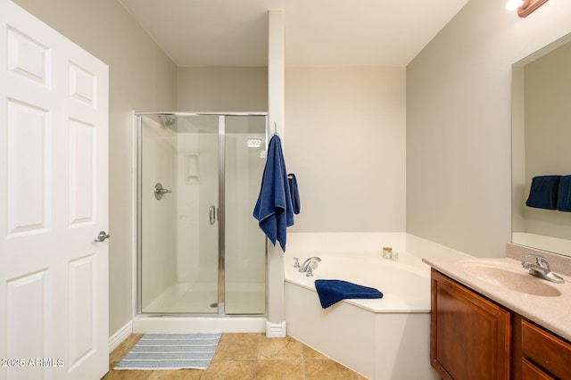 bathroom with tile patterned flooring, a shower stall, a garden tub, and vanity