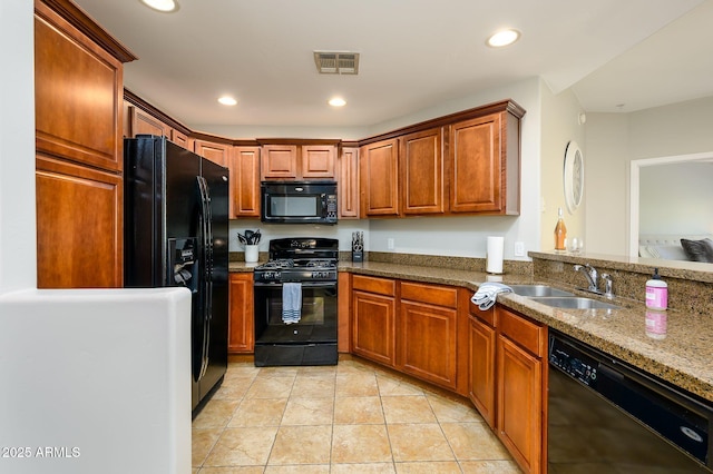 kitchen with a sink, black appliances, recessed lighting, and light tile patterned floors