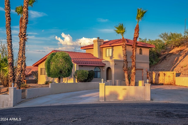 mediterranean / spanish house featuring a garage