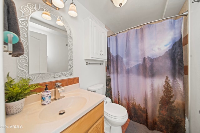 bathroom featuring vanity, toilet, and curtained shower