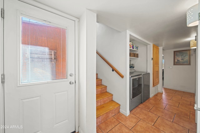 interior space with washing machine and dryer and light tile patterned flooring