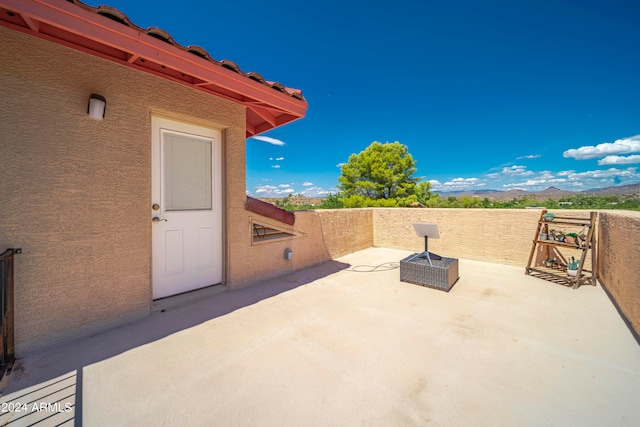 view of patio / terrace with a mountain view and a balcony