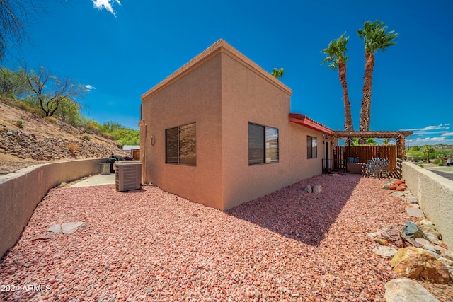 view of side of home featuring cooling unit