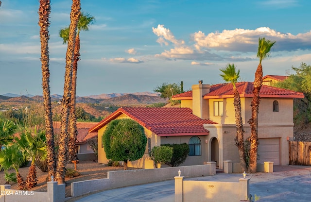 mediterranean / spanish home with a mountain view and a garage