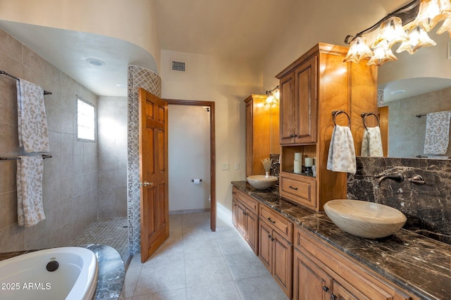 bathroom with vanity, independent shower and bath, and tile patterned flooring