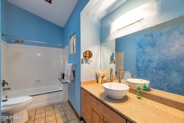 full bathroom featuring toilet, tub / shower combination, vaulted ceiling, vanity, and tile patterned flooring