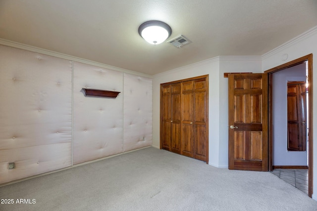 unfurnished bedroom with a closet, ornamental molding, and light carpet