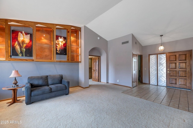 carpeted living room featuring vaulted ceiling