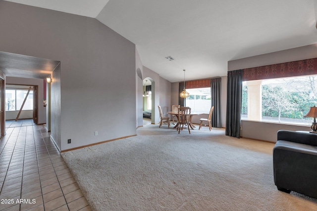 living room featuring light carpet and high vaulted ceiling