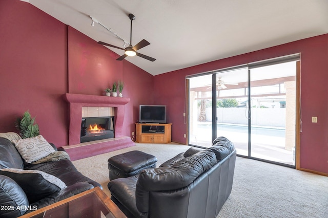 carpeted living room featuring ceiling fan, lofted ceiling, and rail lighting