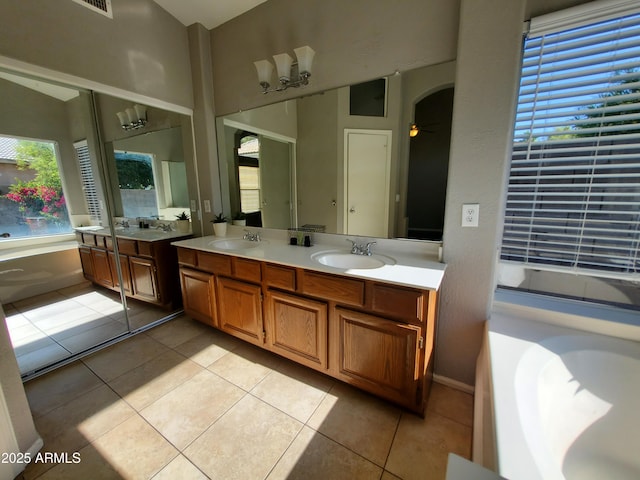 351 S Apache Dr, Chandler, AZ 85224 - bathroom featuring double vanity, a garden tub, tile patterned floors, and a ceiling fan