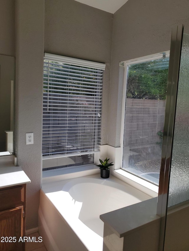 351 S Apache Dr, Chandler, AZ 85224 - bathroom with vanity, a garden tub, and a textured wall