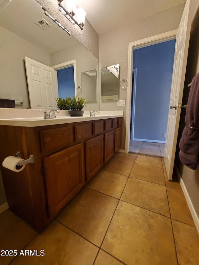 351 S Apache Dr, Chandler, AZ 85224 - bathroom with double vanity, tile patterned floors, and baseboards