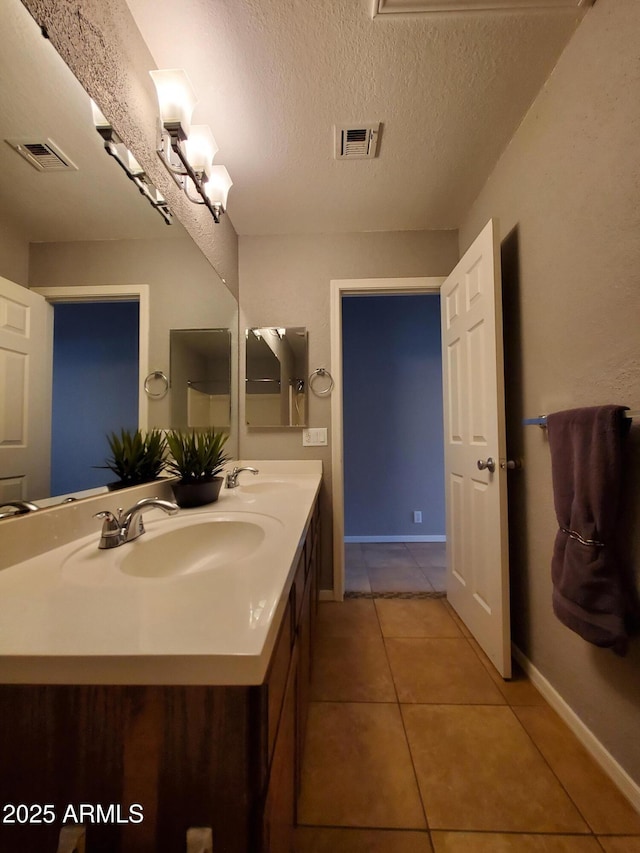 351 S Apache Dr, Chandler, AZ 85224 - bathroom with double vanity, tile patterned floors, baseboards, and a textured ceiling