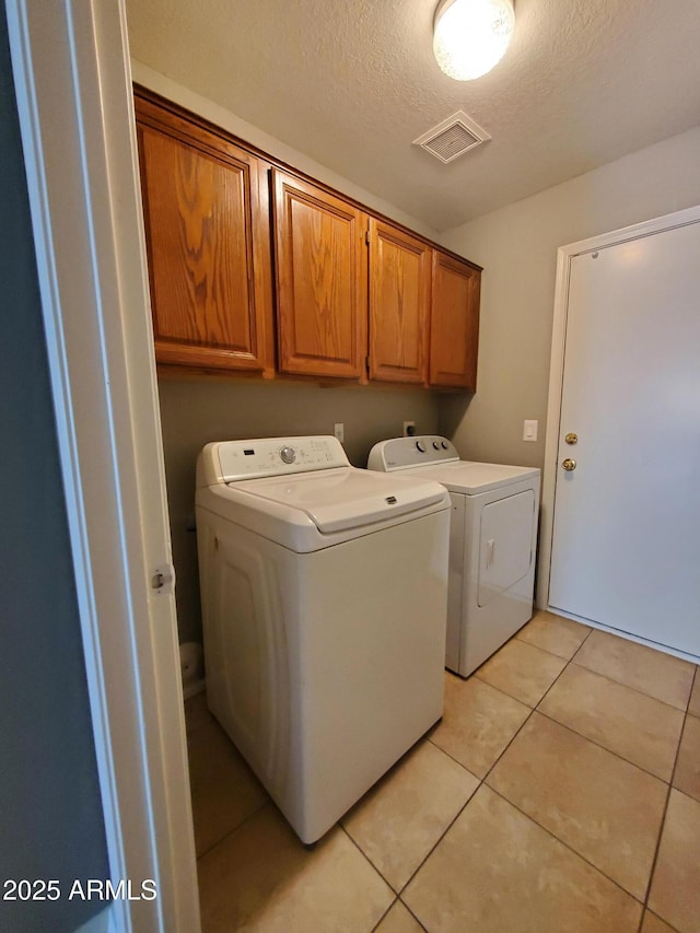 351 S Apache Dr, Chandler, AZ 85224 - washroom featuring washer and dryer, cabinet space, light tile patterned floors, and a textured ceiling