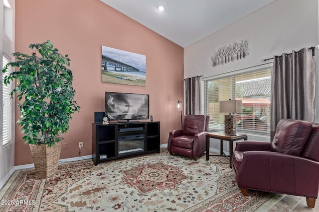 sitting room with high vaulted ceiling