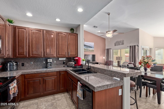 kitchen featuring black dishwasher, sink, kitchen peninsula, backsplash, and lofted ceiling