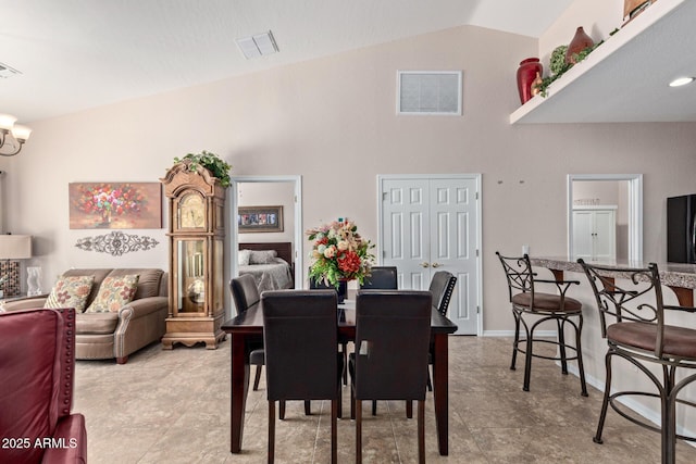 dining area featuring an inviting chandelier and vaulted ceiling