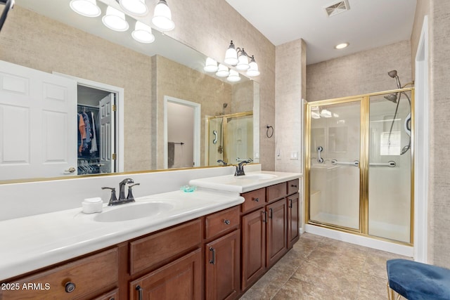 bathroom with walk in shower and vanity